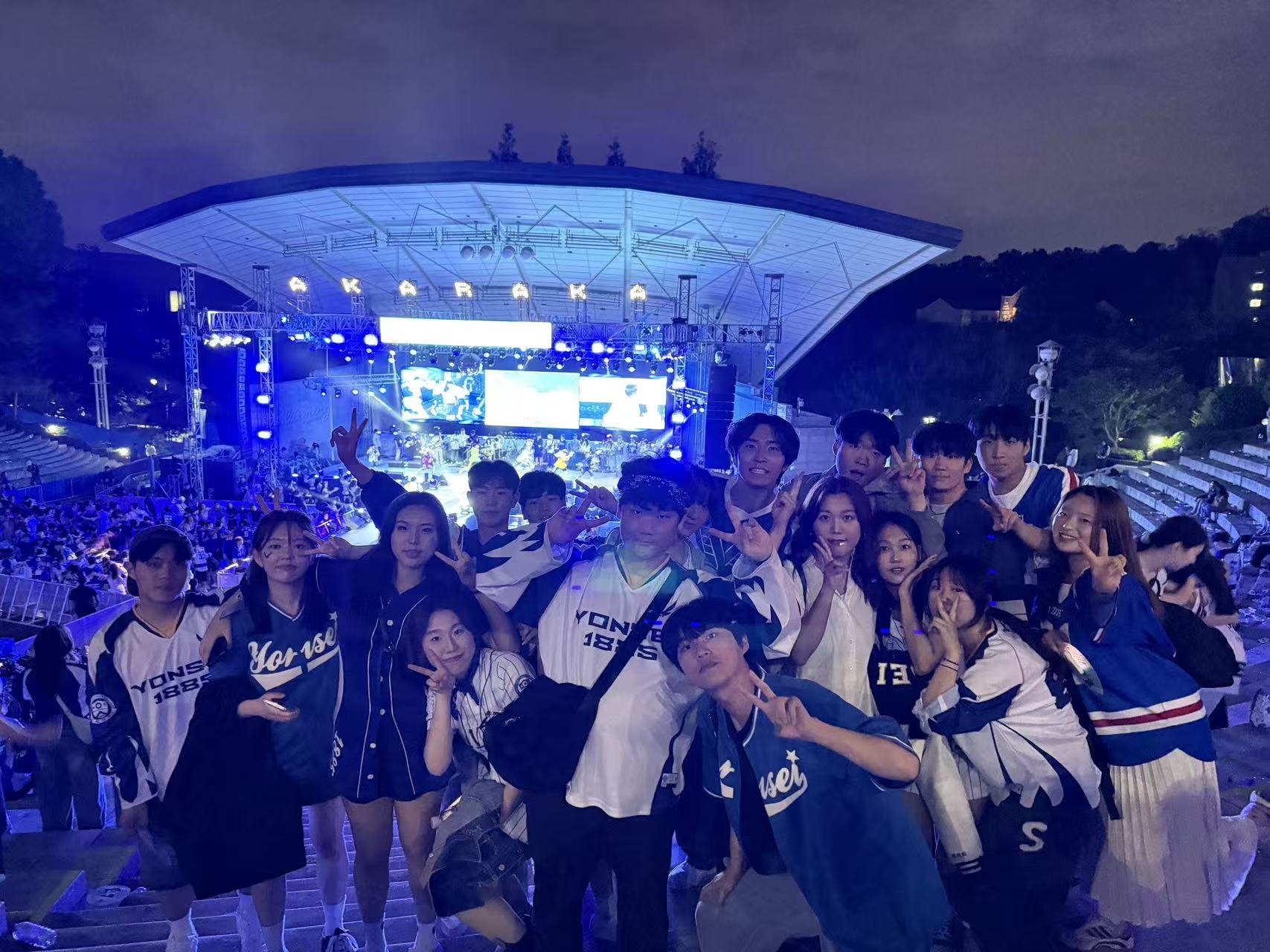 Yonsei University students smile at a concert in Seoul, South Korea